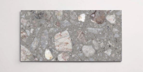 A single grey terrazzo marble tile with various sized aggregates throughout