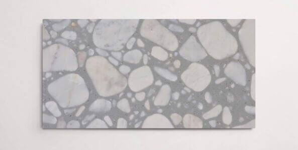 A single grey terrazzo marble tile with various sized aggregates throughout