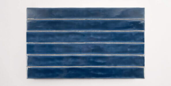 Six stacked 2" x 20" ceramic tiles in a dark blue color