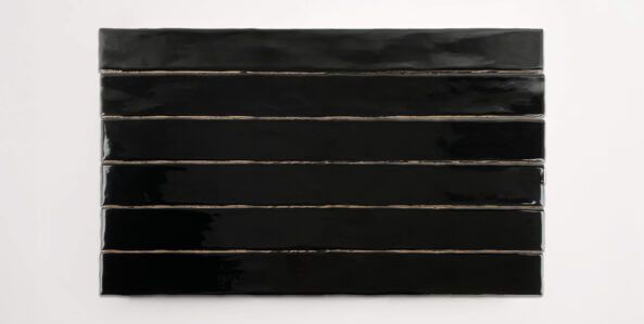 Six stacked 2" x 20" black ceramic tiles in a glossy finish