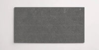 A single dark grey 10" x 30" porcelain tile resembling stone with a textured finish