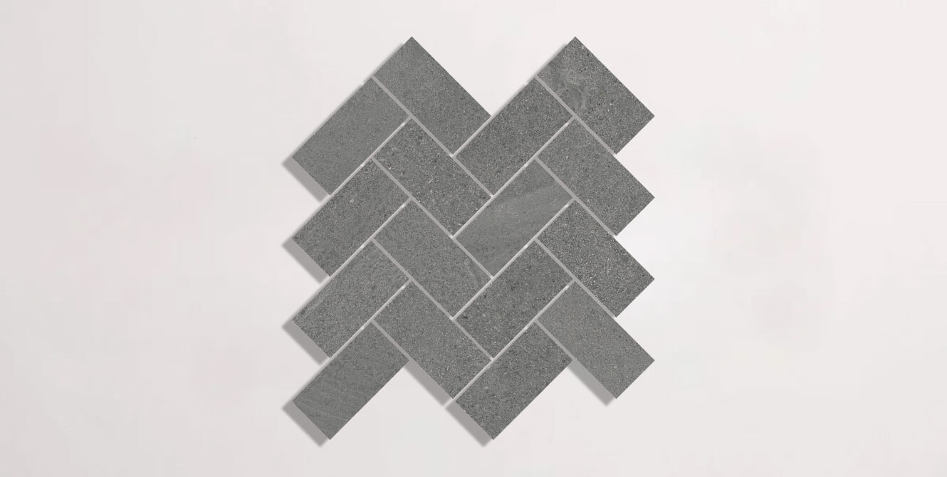 Nasco Stone + Tile Newen Anthracite Herringbone Mosaic porcelain tile.