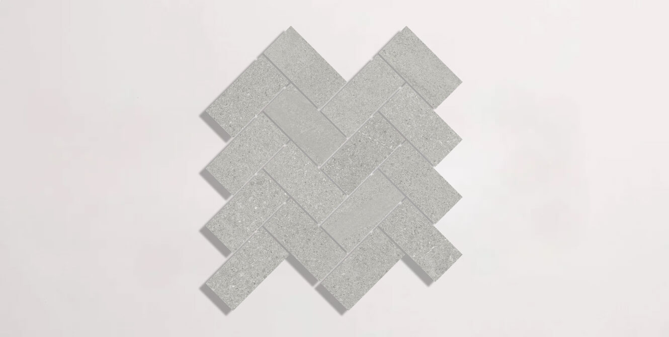 Nasco Stone + Tile Newen Grey Herringbone Mosaic porcelain tile.